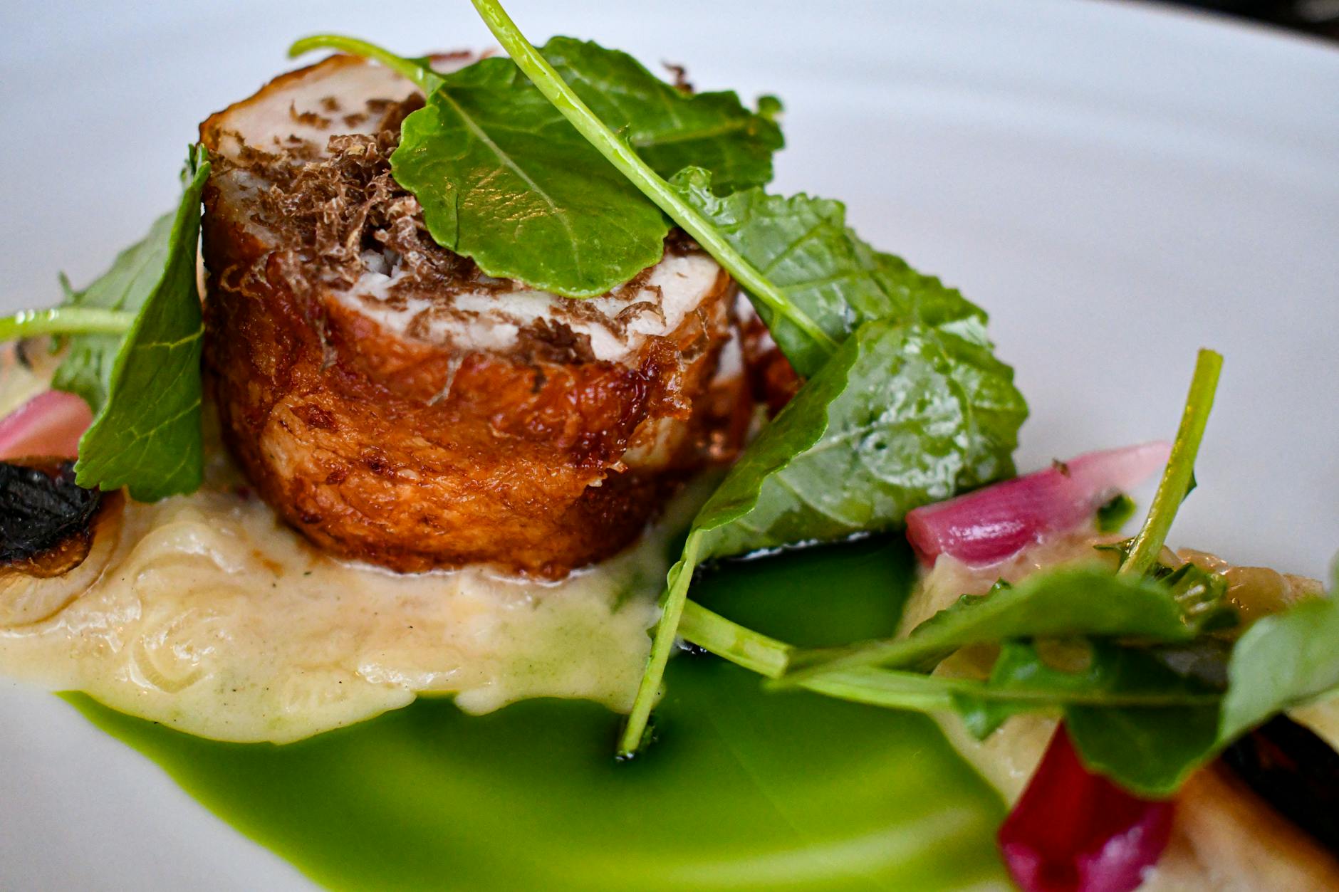 A plated fine dining dish with truffle shavings and microgreens at a New York City restaurant