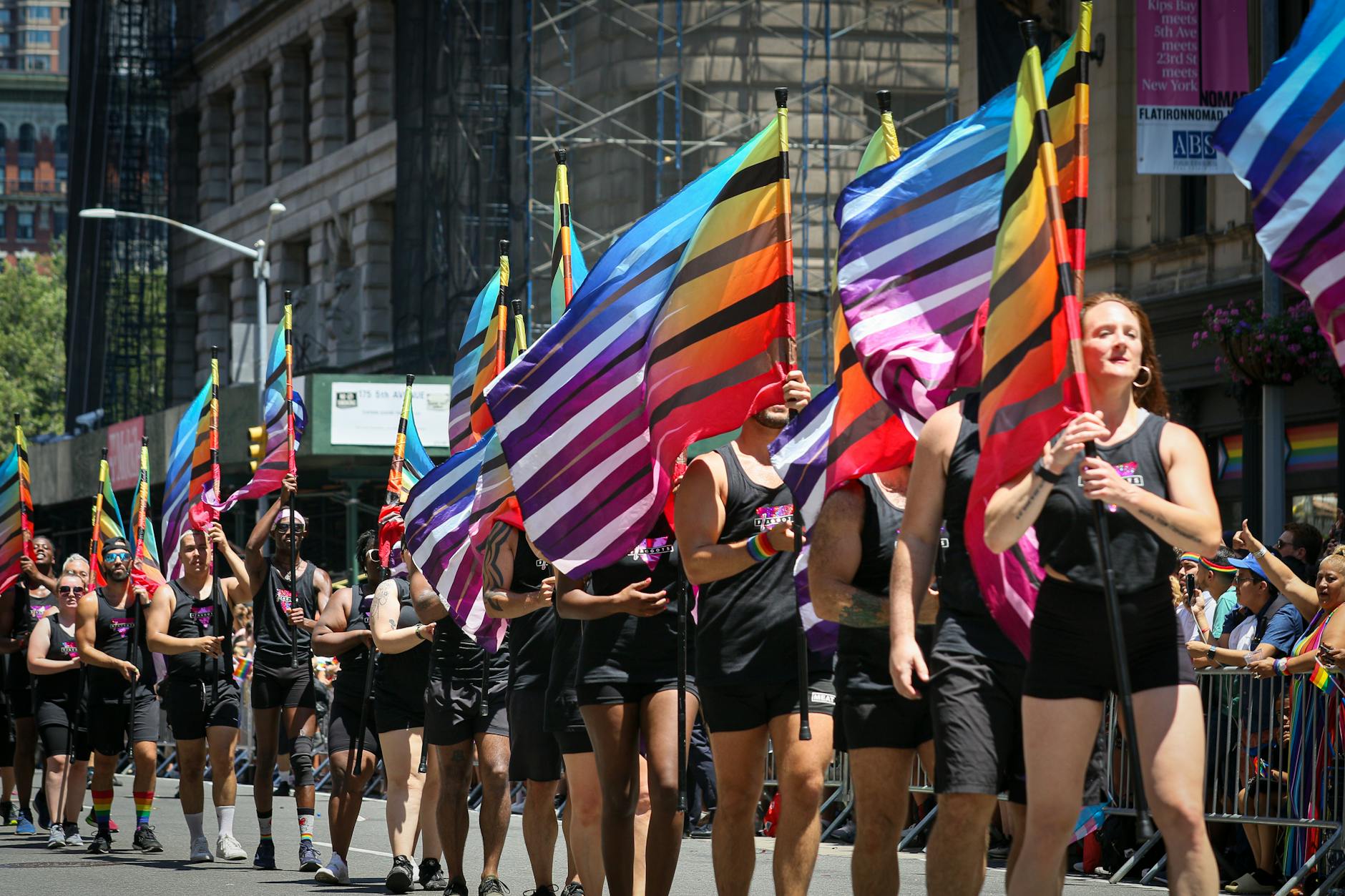 A lively Pride Parade with colorful flags in New York, showcasing diverse participants celebrating LGBTQ culture.